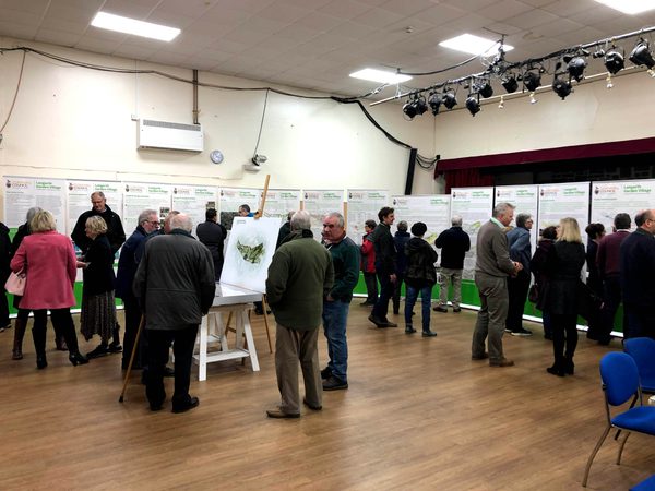 A room full of people surrounded by visual boards as part of the stakeholder engagement process for planning Langarth Garden Village.