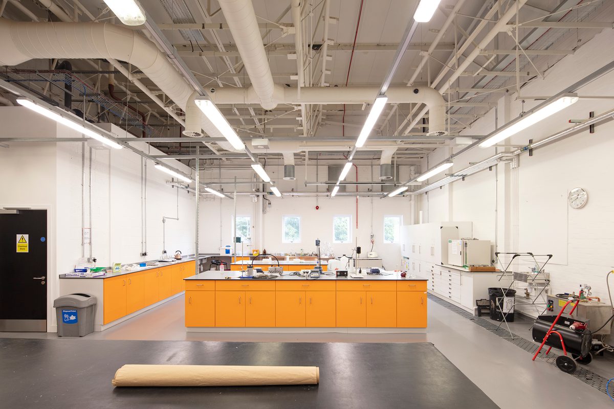 A large, bright facility within the Laura Annie Wilson Building, with kitchen and food preparation facilities and bright orange detailing.