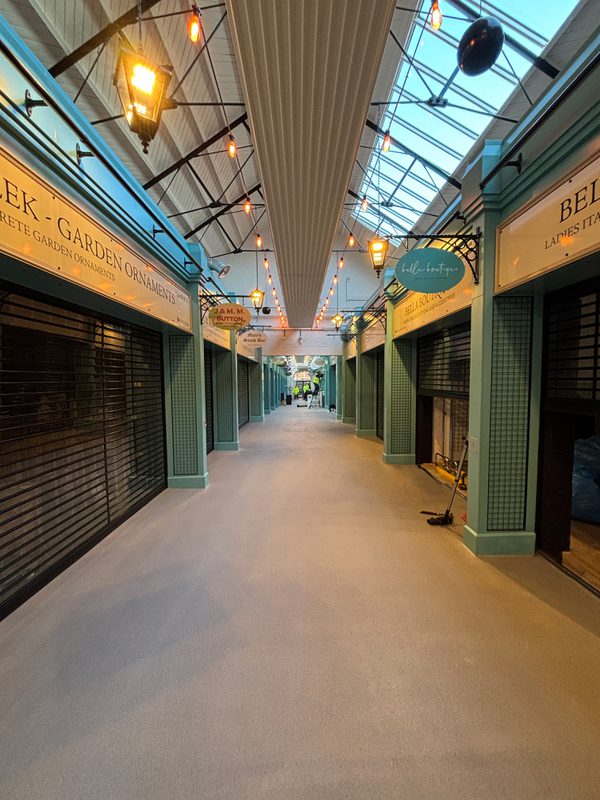 An empty avenue inside Leek's indoor market showing the vast space for various vendors.