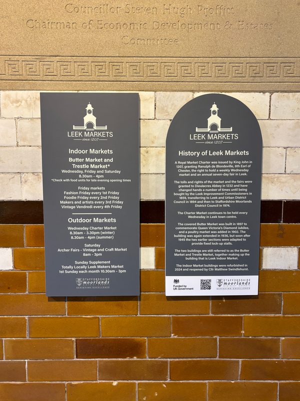 Two plaques detailing the history of Leek's indoor market inside the converted town hall.