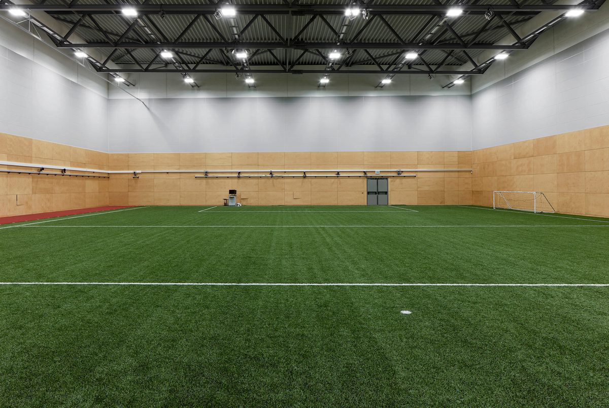 An indoor football pitch within the Manchester Institute of Health and Performance.