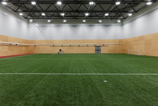 An indoor football pitch within the Manchester Institute of Health and Performance.