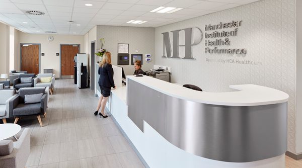 The bright, light, modern reception area of the Manchester Institute of Health and Performance.