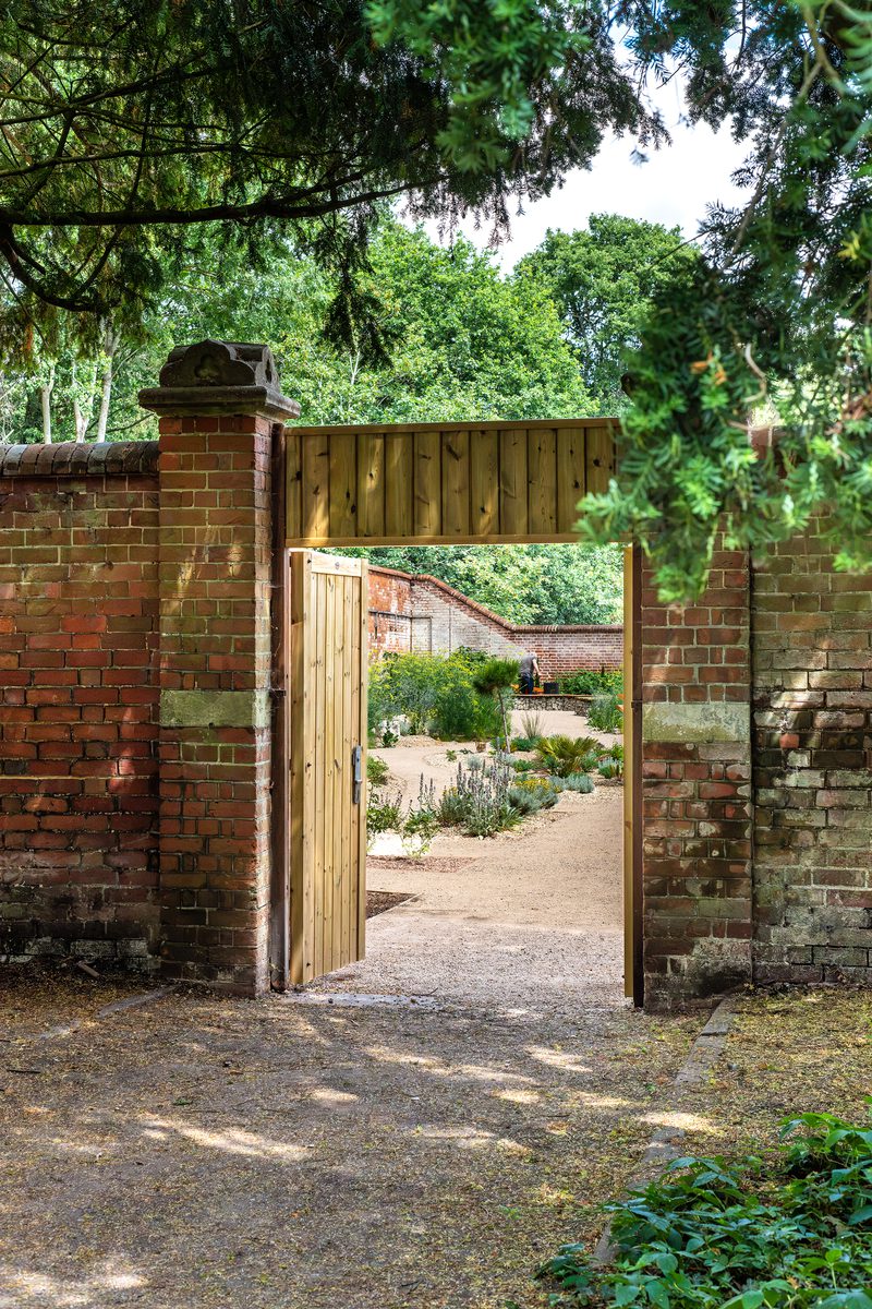An external portrait image of the walled entrance to the new nature and learning garden at the University of Reading.