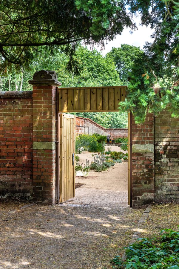 An external portrait image of the walled entrance to the new nature and learning garden at the University of Reading.
