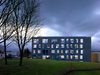 Exterior facade shot of Oldham College at dusk showing its setting within the wider green campus masterplan.