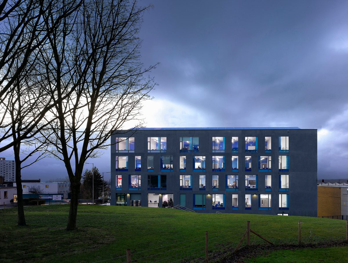 Exterior facade shot of Oldham College at dusk showing its setting within the wider green campus masterplan.