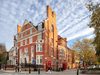 Street-facing view of the Olive School in Hackney, reusing the Grade II listed former police station while retaining its red brick character.