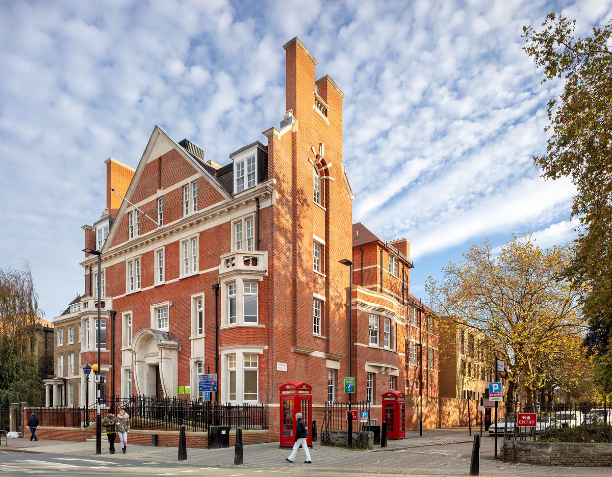 Street-facing view of the Olive School in Hackney, reusing the Grade II listed former police station while retaining its red brick character.