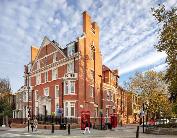 Street-facing view of the Olive School in Hackney, reusing the Grade II listed former police station while retaining its red brick character.