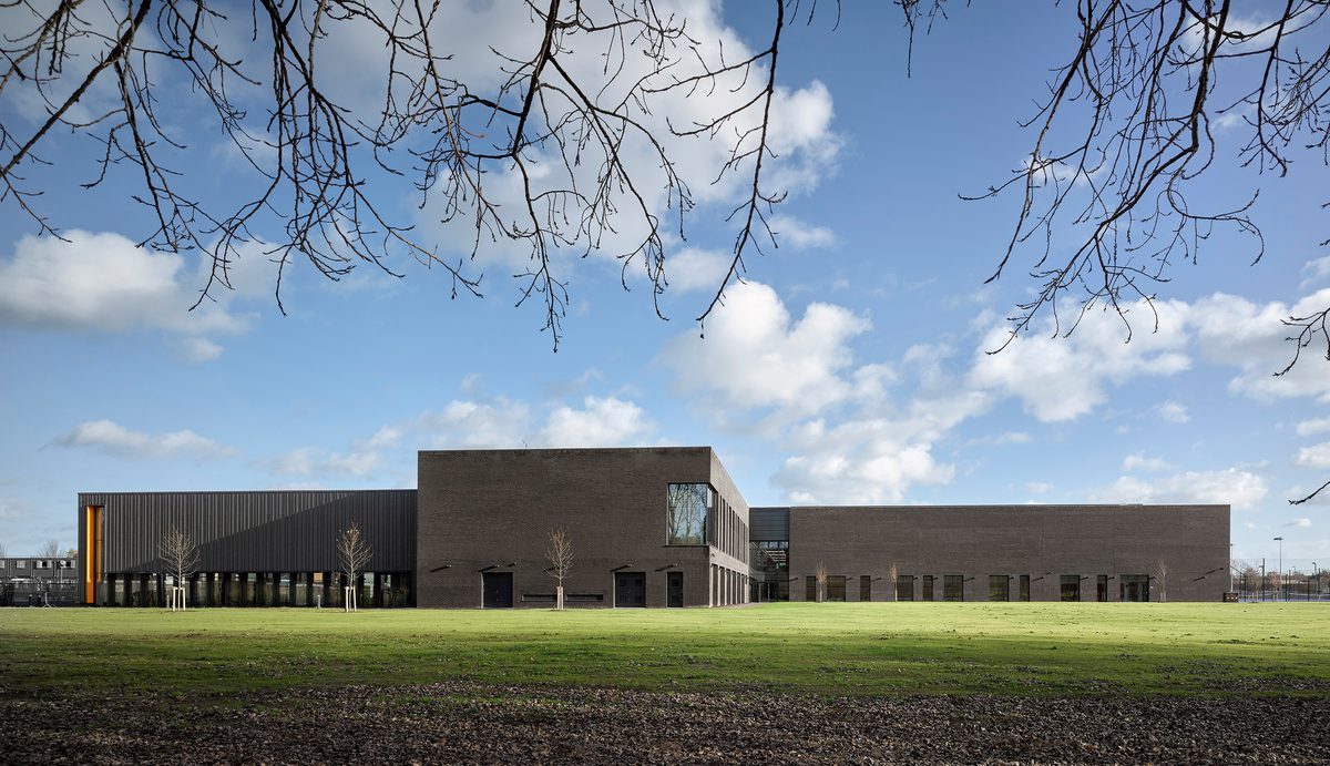 Elevation of the Places Leisure Eastleigh community building surrounded by fields on a sunny day.