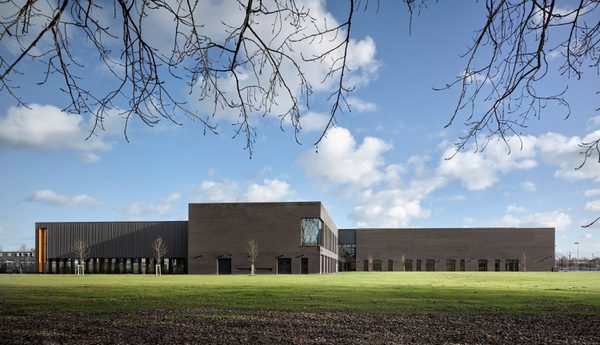 Elevation of the Places Leisure Eastleigh community building surrounded by fields on a sunny day.