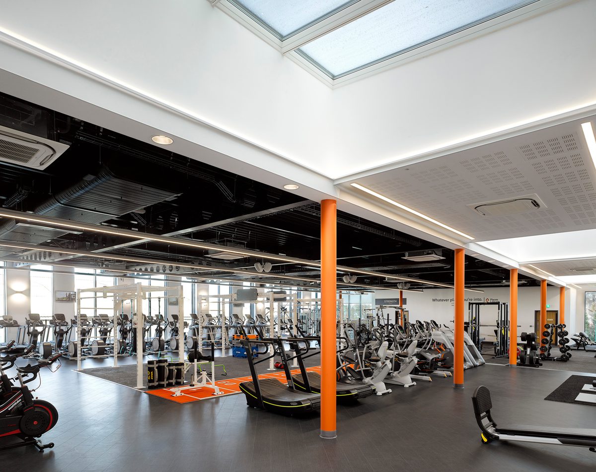 The naturally lit gym space inside the leisure centre showing various equipment for community use.