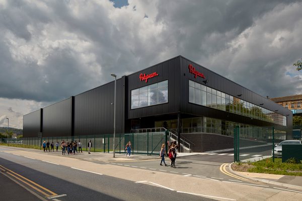 The large, black exterior of Polyseam Manufacturing Unit showing the development in its entirety.