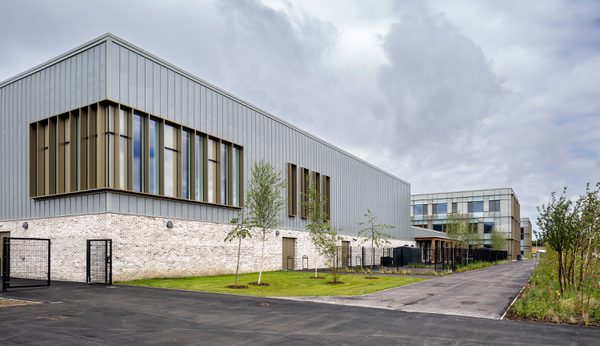 The exterior wall of the Woodmill and St Columba's RC High School, showing the large scale of the school, and landscaped planting surrounding the school.