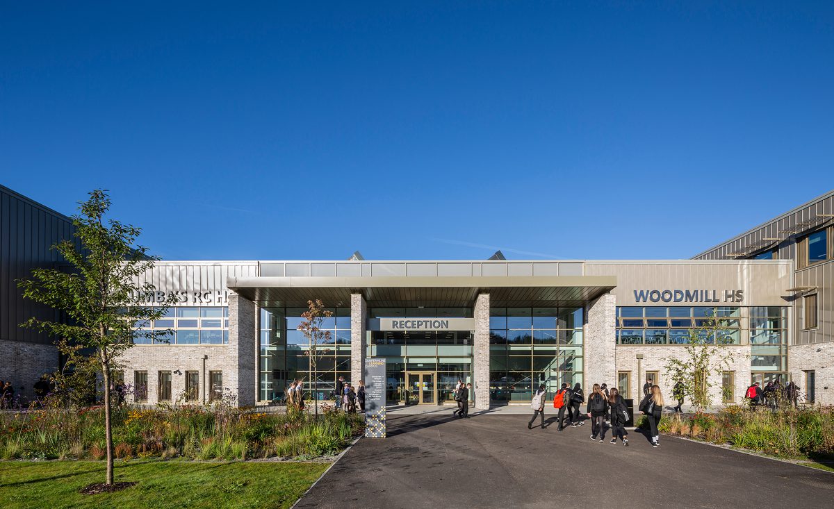 Pupils walking around the landscaped entrance to the Woodmill and St Columba's RC High School, surrounded by biodiverse planting.