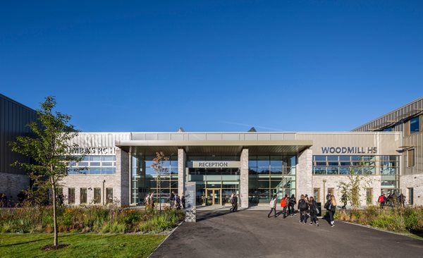 Pupils walking around the landscaped entrance to the Woodmill and St Columba's RC High School, surrounded by biodiverse planting.