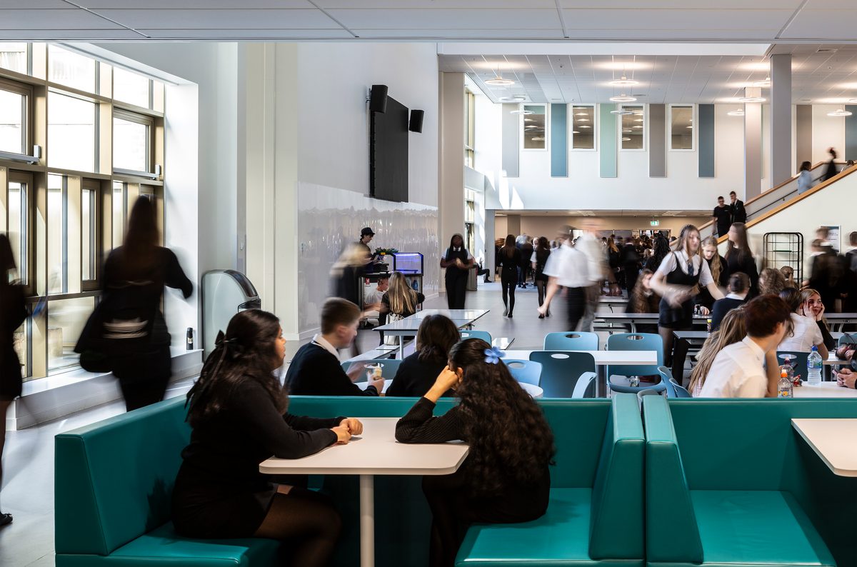 Pupils enjoying the variety of seating options within the dining hall of the Woodmill and St Columba's RC High School.