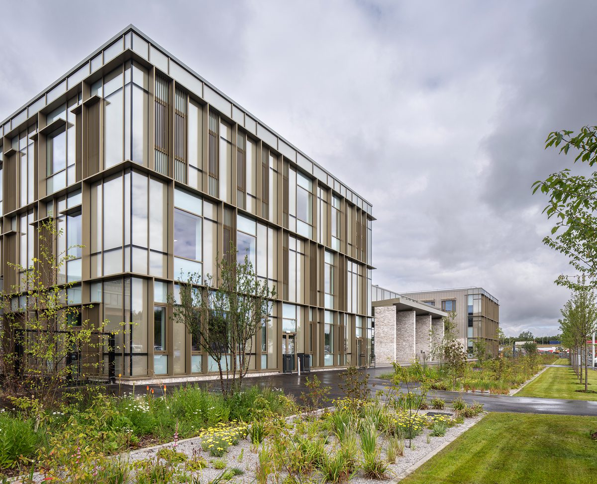 Exterior of Woodmill and St Columba's RC High School showing high performance glazing and landscaped planted area.