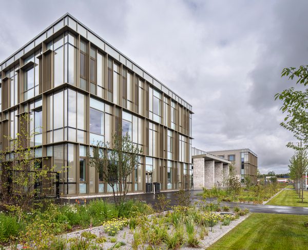 Exterior of Woodmill and St Columba's RC High School showing high performance glazing and landscaped planted area.