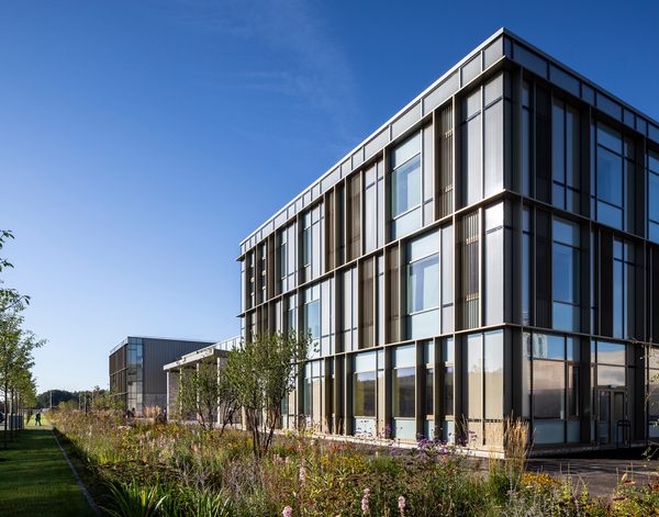 Exterior of Woodmill and St Columba's RC High School showing high performance glazing and landscaped planted area.