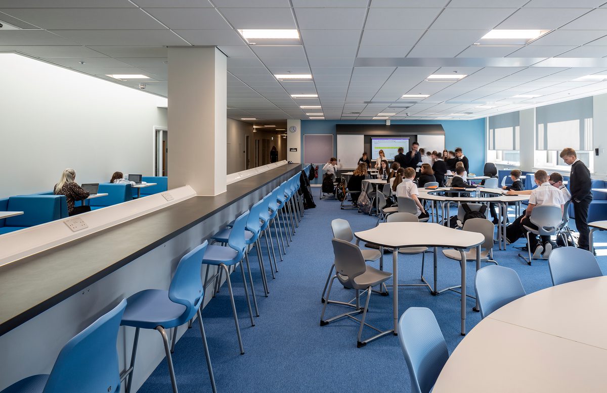 Pupils using a variety of workspaces within a classroom of the Woodmill and St Columba's RC High School.