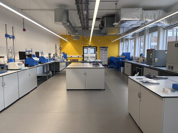 The state of the art interior of the newly refurbished Robert Blackburn Laboratory, with specialist engineering equipment and large external windows along one side of the room.