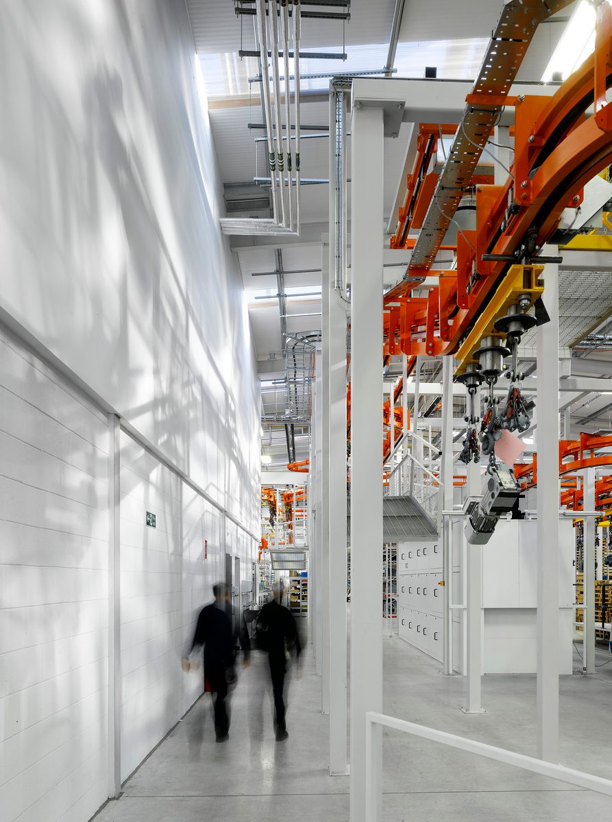 People walking through the large warehouse facilities at SEW Eurodrive UK Headquarters.