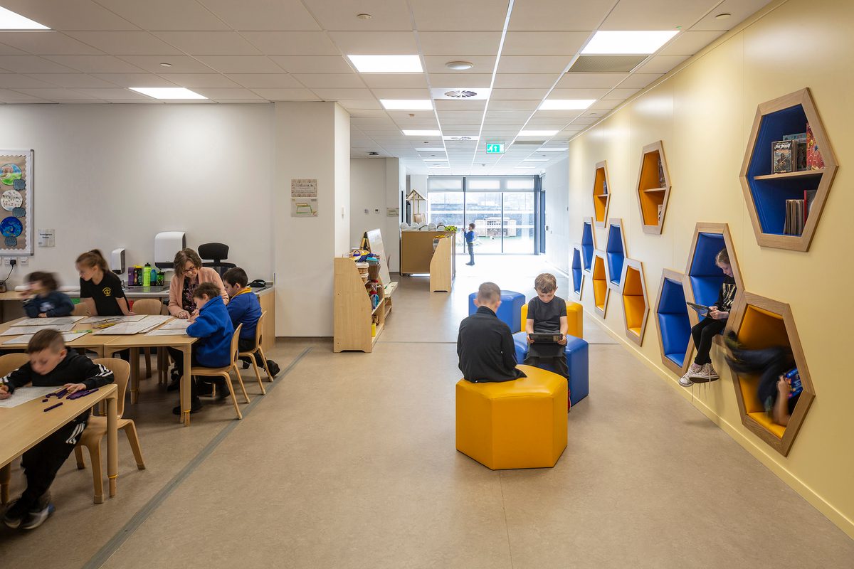Sacred Heart Primary School workspaces with pupils using traditional tables and individual learning pods.