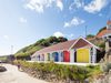 A row of rebuilt colourful beach chalets on Scarborough's South Cliff.