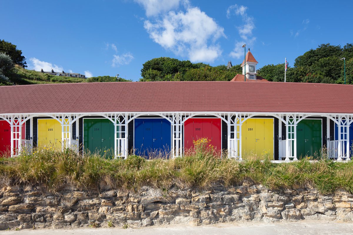 A front view of the rebuilt beach chalets on Scarborough's South Cliff, with colourful doors.