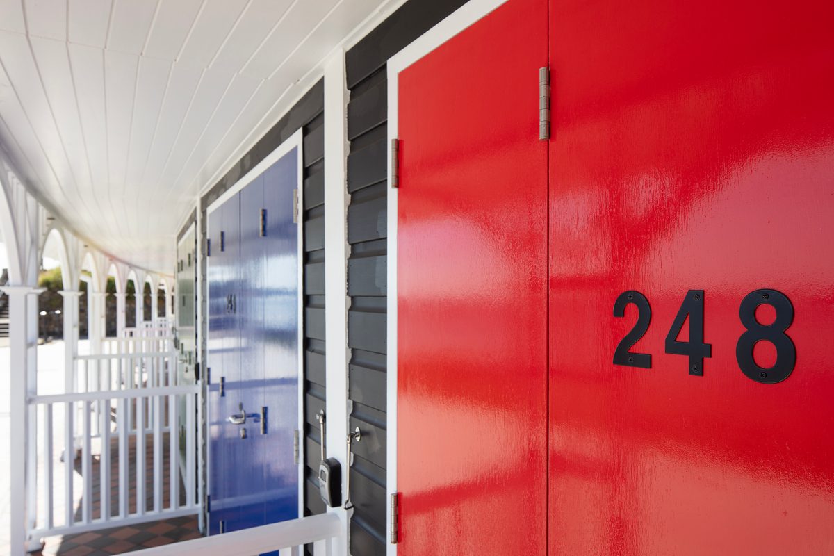 A detail shot of a red front door of one of the restored colourful beach chalets on Scarborough's South Cliff.