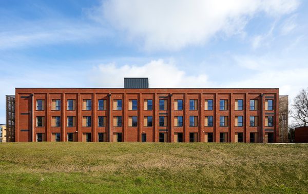 Elevation of the Stafford Barracks on a bright, sunny day with green grass in the foreground.