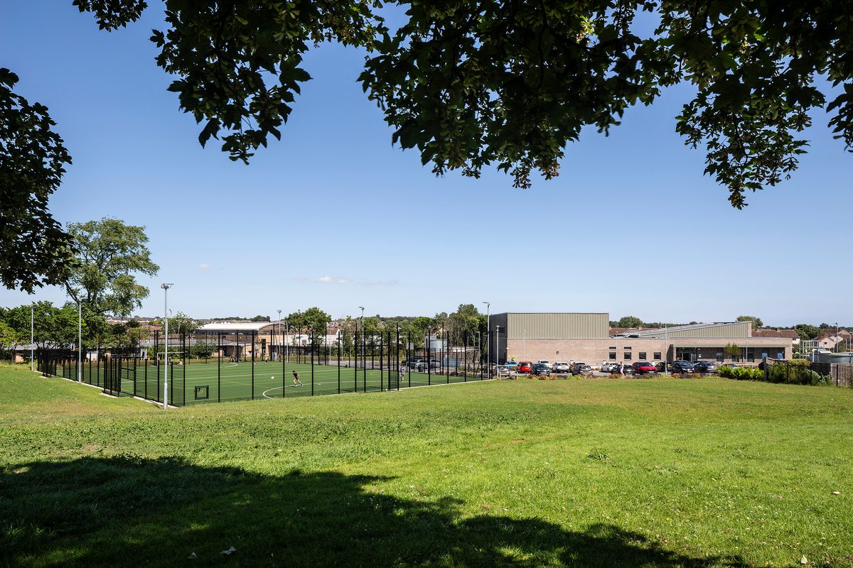 A wide view of the external garden and greenery as part of Templehall Community Hub on a bright, sunny day.
