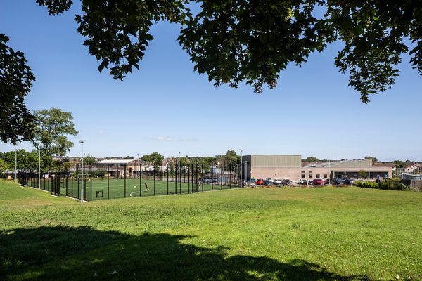 A wide view of the external garden and greenery as part of Templehall Community Hub on a bright, sunny day.