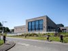 On approach to Templehall Community Hub from the street with visitors walking along the pathway on a bright sunny day.