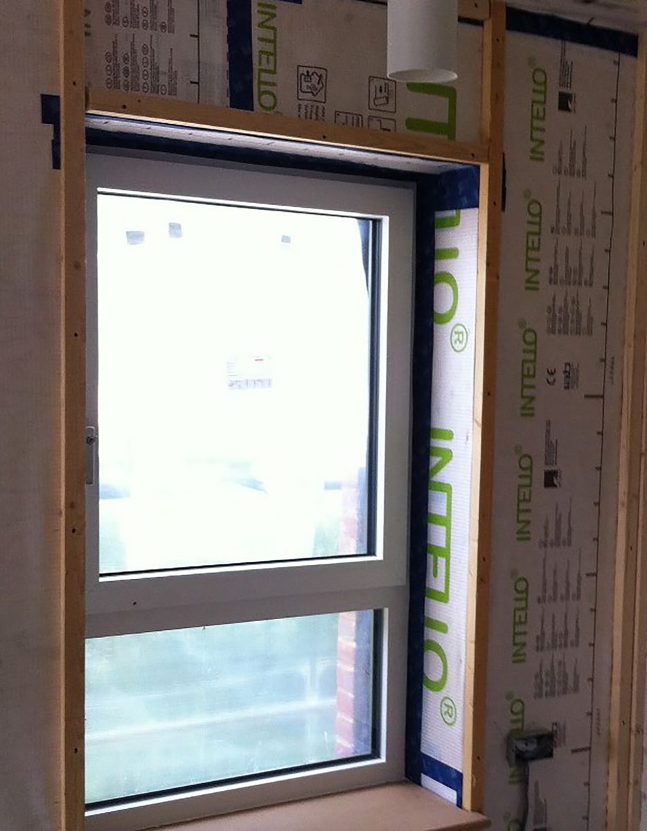 A construction shot, detailing the internal joins and insulating material, between the walls and a window, used in the housing within the residential development at the Pheasantry.