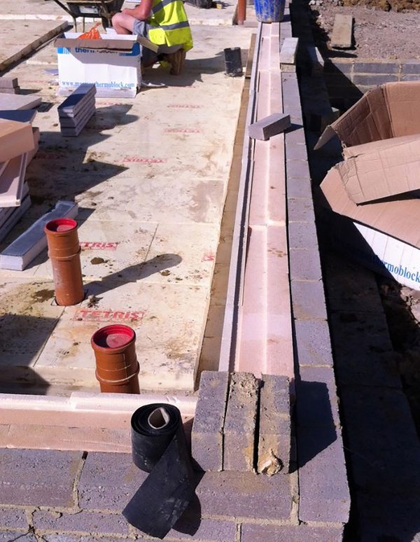 A construction shot, detailing the insulation between cavity walls within one of the houses within the residential development at the Pheasantry.