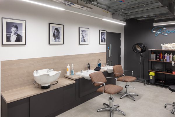 A couple of hair wash stations inside the Sheffield College's City Campus designed with space surrounding them.