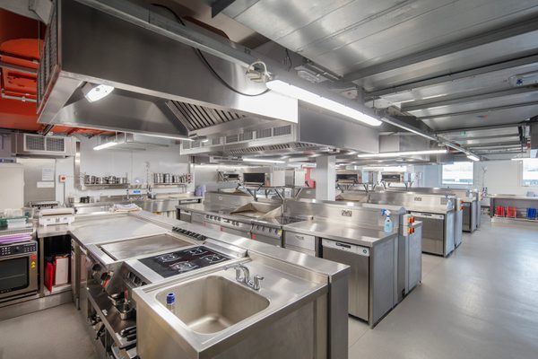 A wide internal shot of the catering and hospitality space inside the Sheffield College's City Campus with rows of workspaces.