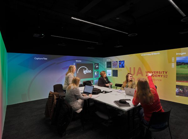 Immersive virtual reality room at University Academy 92 (UA92) showing colorful graphics and collaborative seating areas.