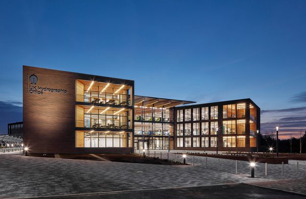 The whole exterior of the UK Hydrographic Office at dusk, showing the exceptional number of windows in the office.