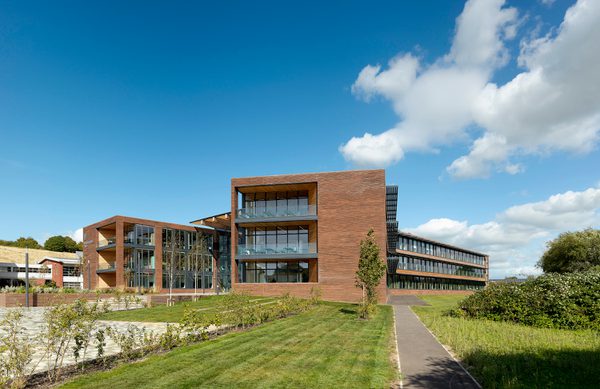 The exterior side of the UK Hydrographic Office, showing the high level of glazing, balconies and planting surrounding the building.