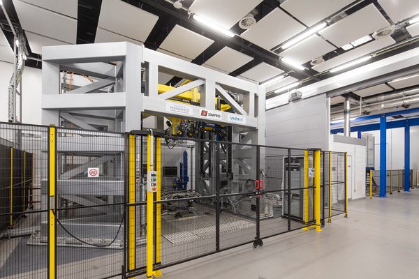 Heavy machinery protected by a fence, in an interior workshop at the UK Institute of Railway Research.