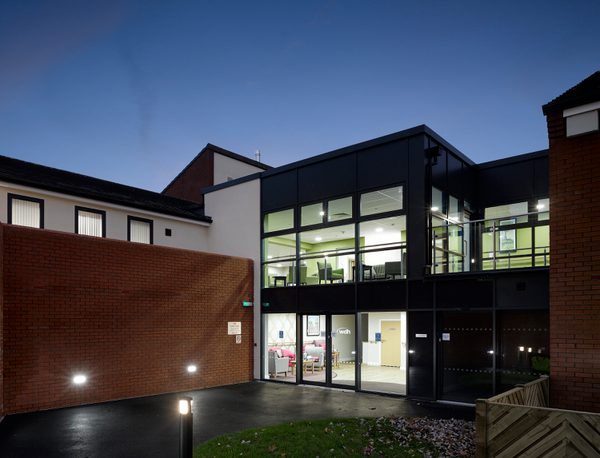 The exterior entrance of one of the Independent Living Schemes in Vico Homes' property portfolio at night.