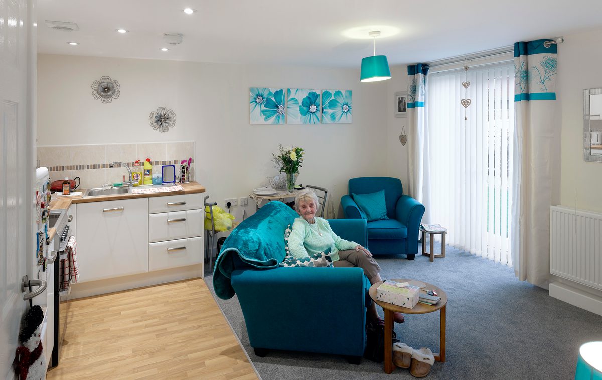 A resident sitting within her living area in one of the Independent Living Schemes in Vico Homes' property portfolio.