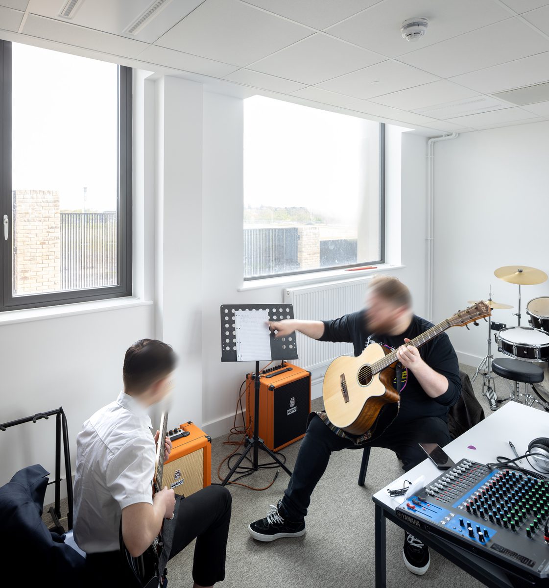 A lesson going on in a music studio, within the Winterstoke Hundred Academy.
