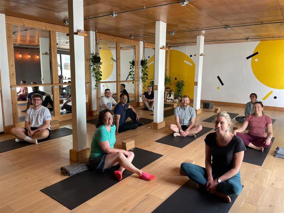 The Bristol team relax and prioritise their wellbeing by taking part in a yoga class together.